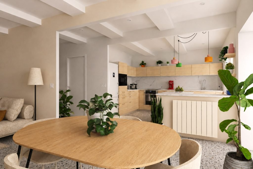 Cuisine ouverte en bois clair donnant sur la salle à manger, avec sol en terrazzo et suspensions colorées.
