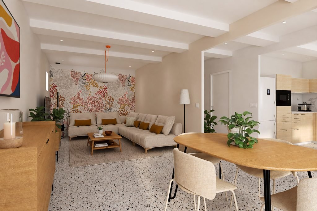 Vue d’ensemble du salon ouvert sur la salle à manger et la cuisine, avec canapé écru, tapisserie corail, mobilier en bois et terrazzo existant conservé.