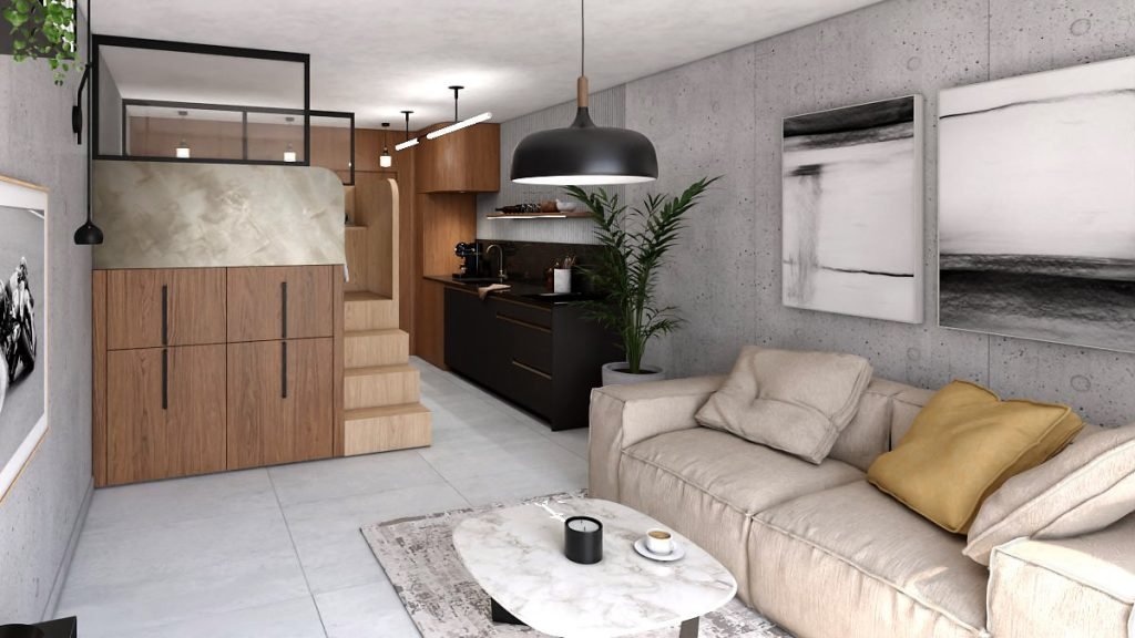 Espace de vie du studio avec salon, cuisine noire et cube multifonction en bois intégrant l’escalier et les rangements.