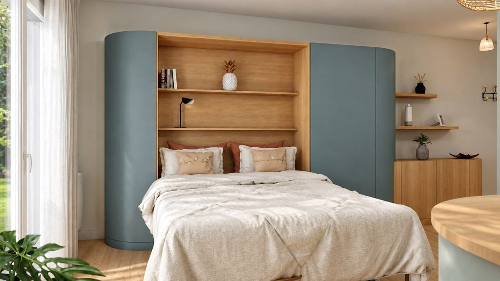 Lit escamotable ouvert intégré à un meuble sur mesure vert profond et bois, dans la pièce de vie lumineuse du studio.