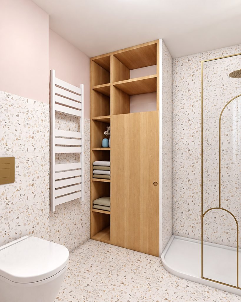 Placard sur mesure en bois dissimulant la machine à laver, avec niches de rangement aménagées entre les toilettes et la douche.