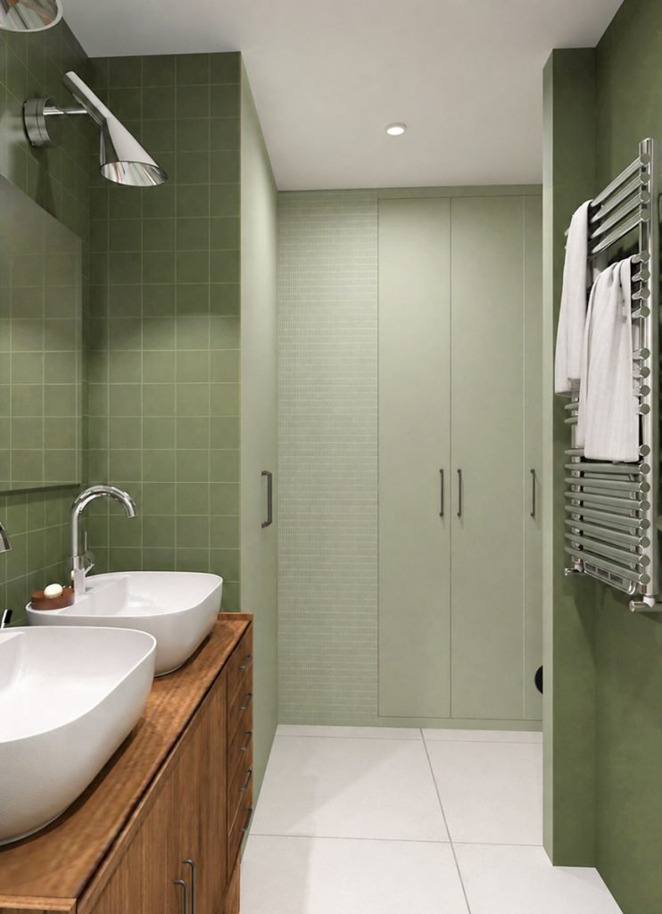 Salle d’eau parentale verte avec meuble en bois à double vasque et buanderie au fond.
